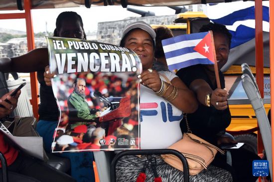 4月2日,民众手持已故古巴革命领袖菲德尔·卡斯特罗的海报在古巴哈瓦那海滨大道参加反对帝国主义、捍卫古巴革命的游行活动。新华社发(华金·埃尔南德斯 摄)